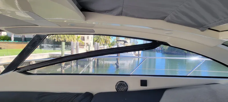  Yacht Photos Pics Interior view of 2013 Azimut Atlantis 44 yacht, showcasing sleek window design and waterfront scenery.