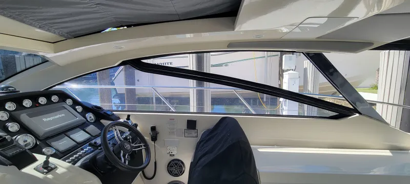  Yacht Photos Pics Interior view of 2013 Azimut Atlantis 44 yacht cockpit with steering wheel and control panel.