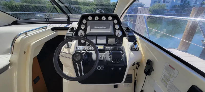  Yacht Photos Pics Helm of 2013 Azimut Atlantis 44 yacht with steering wheel and navigation controls.