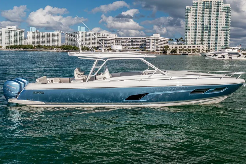  Yacht Photos Pics 2022 Intrepid 409 Valor boat on water with cityscape background.