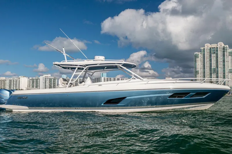  Yacht Photos Pics 2022 Intrepid 409 Valor boat on water with cityscape background.