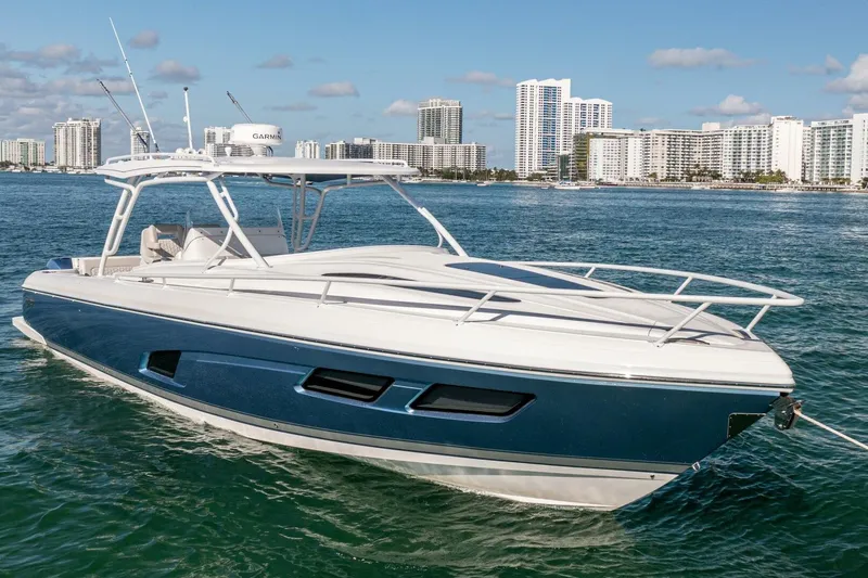  Yacht Photos Pics 2022 Intrepid 409 Valor boat on water with city skyline background.