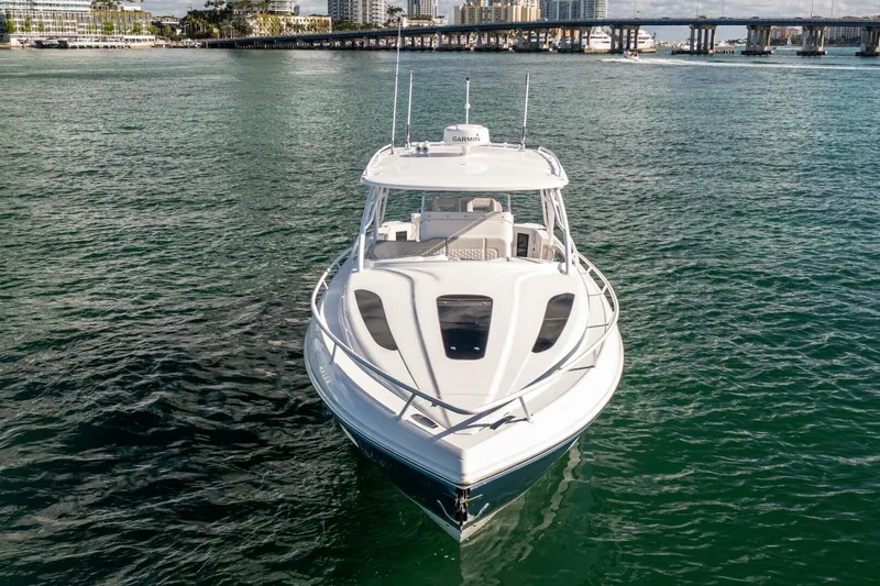  Yacht Photos Pics 2022 Intrepid 409 Valor boat on calm water, cityscape background.