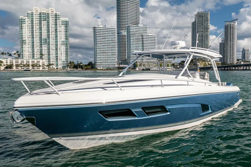  Yacht Photos Pics 2022 Intrepid 409 Valor boat on water with city skyline background.