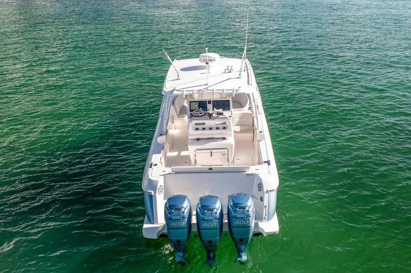  Yacht Photos Pics 2022 Intrepid 409 Valor boat with triple 400 engines on clear water.