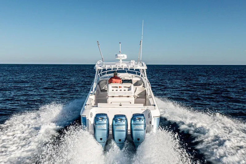  Yacht Photos Pics 2022 Intrepid 409 Valor boat cruising on open sea with triple engines.