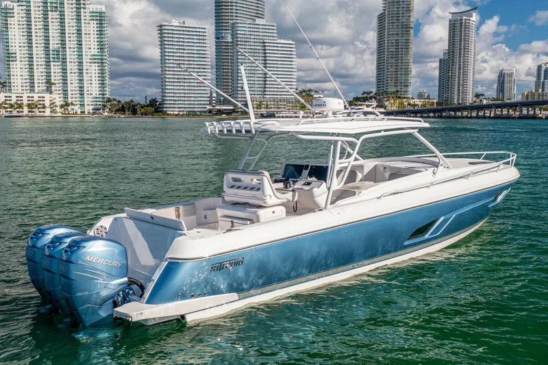  Yacht Photos Pics 2022 Intrepid 409 Valor boat on water with city skyline background.