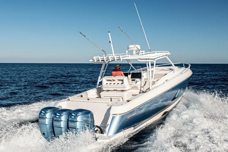  Yacht Photos Pics 2022 Intrepid 409 Valor boat cruising on open sea with triple Mercury engines.