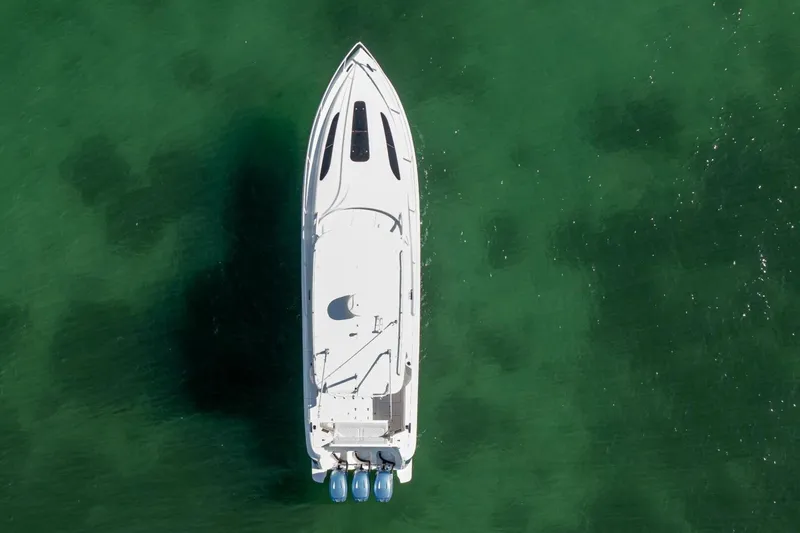  Yacht Photos Pics Aerial view of 2022 Intrepid 409 Valor boat on clear green water.