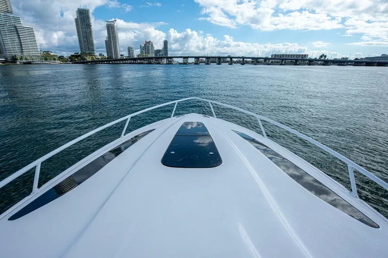  Yacht Photos Pics Bow view of 2022 Intrepid 409 Valor yacht approaching city skyline.