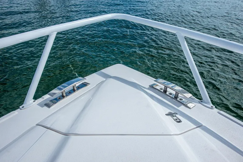  Yacht Photos Pics Bow of 2022 Intrepid 409 Valor boat with stainless steel fittings on calm water.