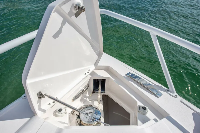  Yacht Photos Pics Open anchor compartment on 2022 Intrepid 409 Valor boat, with ocean in background.