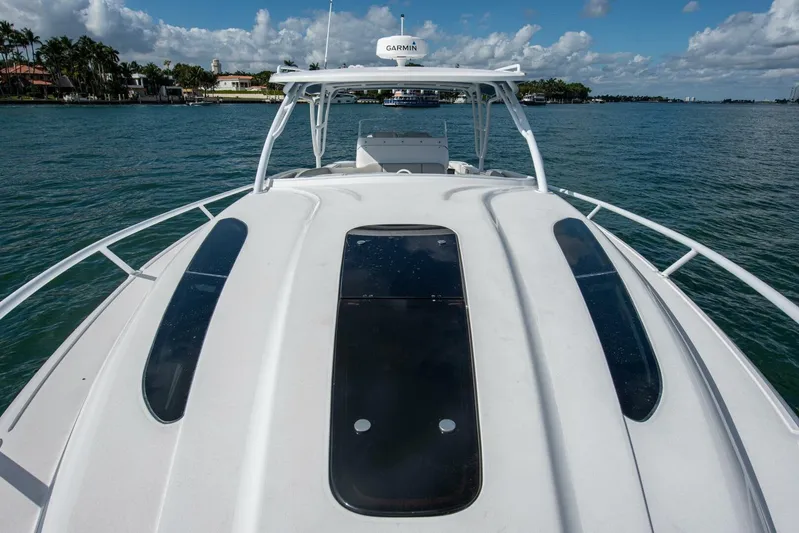  Yacht Photos Pics 2022 Intrepid 409 Valor boat on water, showcasing sleek design and spacious deck.