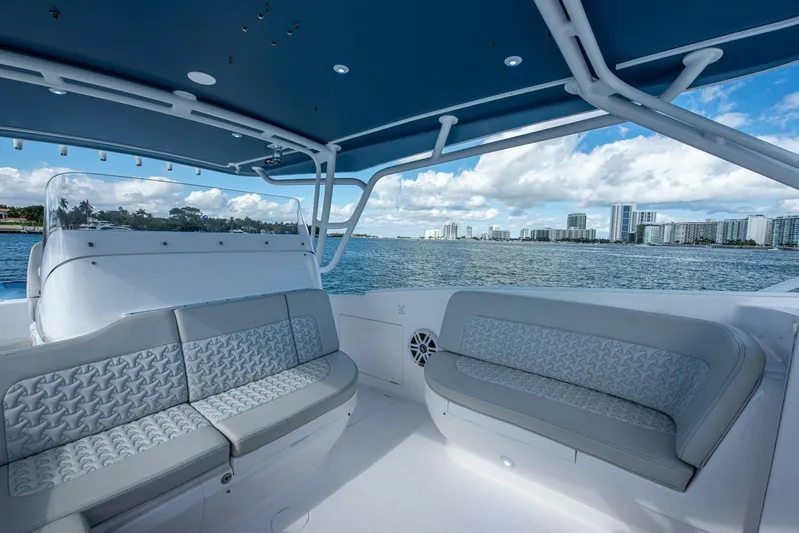  Yacht Photos Pics Luxurious seating on 2022 Intrepid 409 Valor boat with ocean and cityscape view.