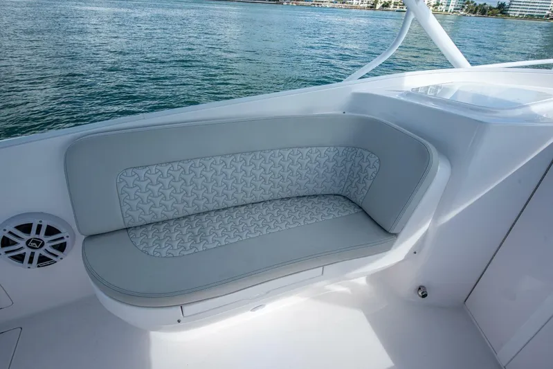  Yacht Photos Pics Luxurious seating on 2022 Intrepid 409 Valor boat with patterned upholstery, near water.