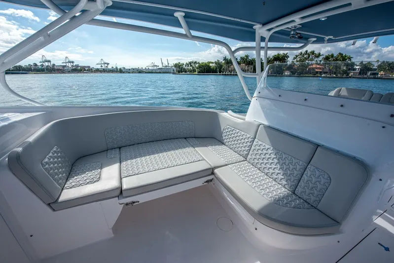  Yacht Photos Pics Luxurious seating on 2022 Intrepid 409 Valor boat, with scenic waterfront view.