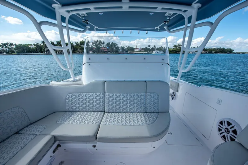  Yacht Photos Pics 2022 Intrepid 409 Valor boat interior with cushioned seating and ocean view.