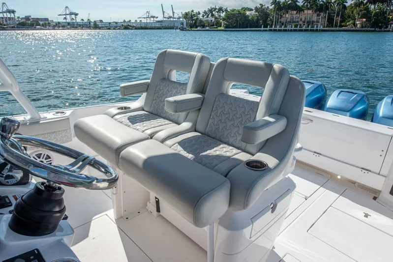  Yacht Photos Pics Luxury seating on 2022 Intrepid 409 Valor boat, with ocean view and modern helm.