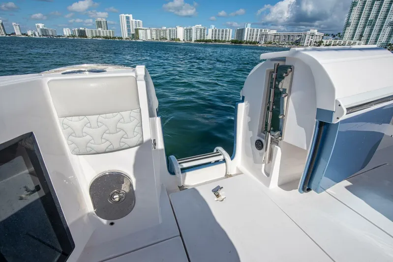  Yacht Photos Pics 2022 Intrepid 409 Valor boat deck with ocean and city skyline view.