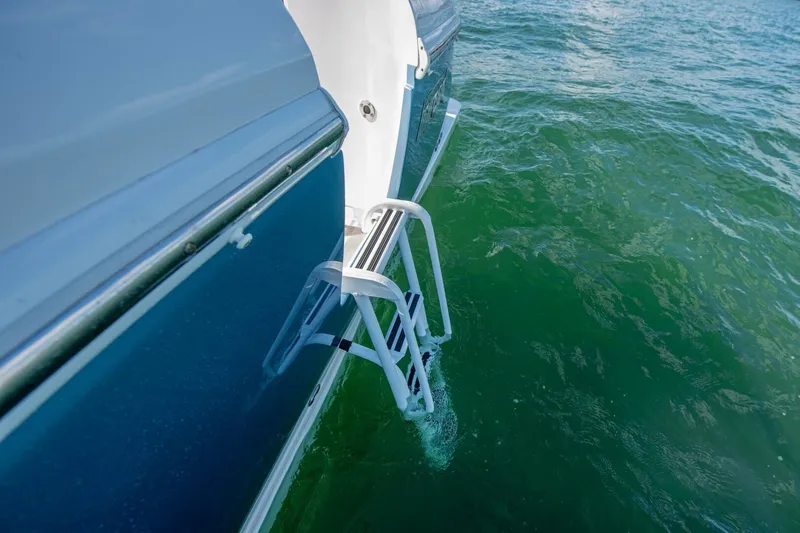  Yacht Photos Pics 2022 Intrepid 409 Valor boat ladder over green water.