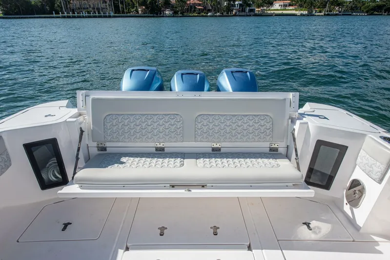  Yacht Photos Pics 2022 Intrepid 409 Valor boat with cushioned seating and triple outboard engines.