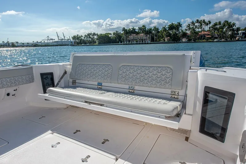  Yacht Photos Pics 2022 Intrepid 409 Valor boat interior with cushioned seating, overlooking scenic waterfront.