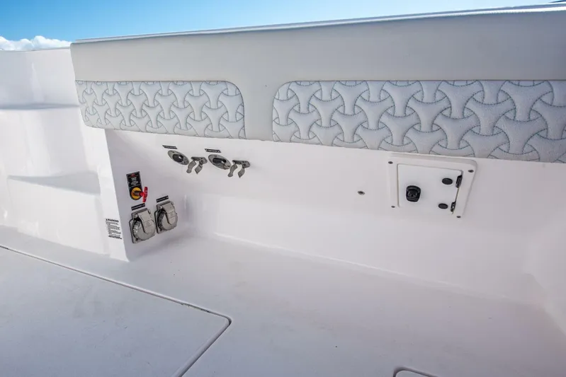  Yacht Photos Pics 2022 Intrepid 409 Valor boat interior with patterned upholstery and control panel.