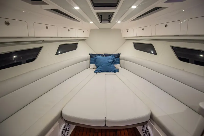  Yacht Photos Pics Luxurious interior of 2022 Intrepid 409 Valor yacht with plush seating and cushions.