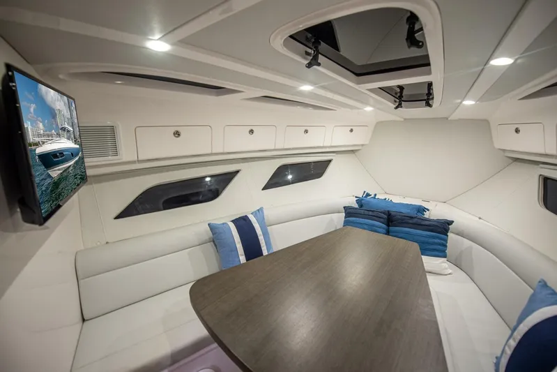  Yacht Photos Pics Interior of 2022 Intrepid 409 Valor yacht with seating, table, and TV.