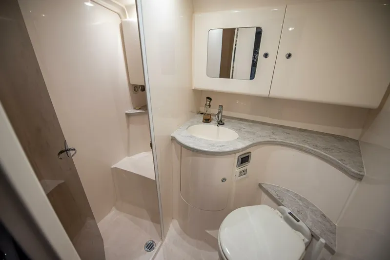  Yacht Photos Pics Luxurious bathroom in 2022 Intrepid 409 Valor yacht with modern fixtures and elegant design.