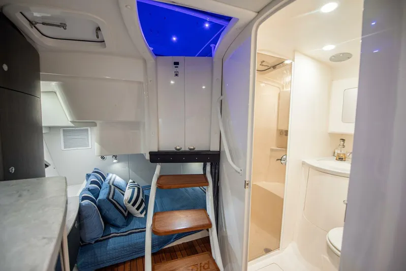 Yacht Photos Pics Interior of 2022 Intrepid 409 Valor boat with cozy cabin and modern bathroom.