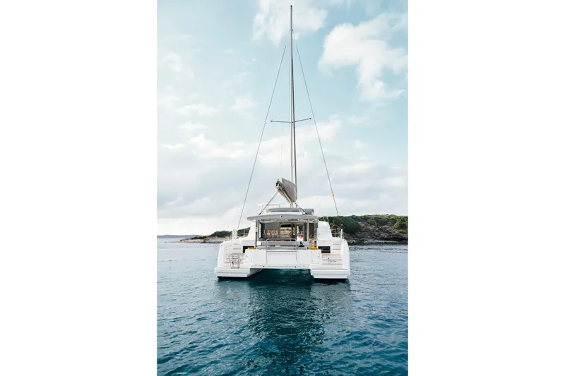  Yacht Photos Pics 2026 Bali 4.4 catamaran on calm sea with scenic coastal backdrop.