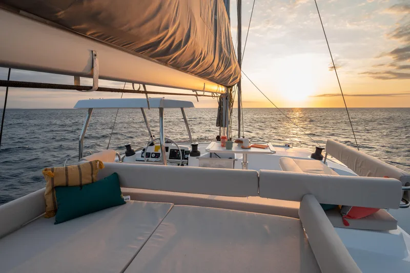  Yacht Photos Pics Luxurious Bali 4.4 catamaran sailing at sunset, 2026 model, with elegant deck seating.