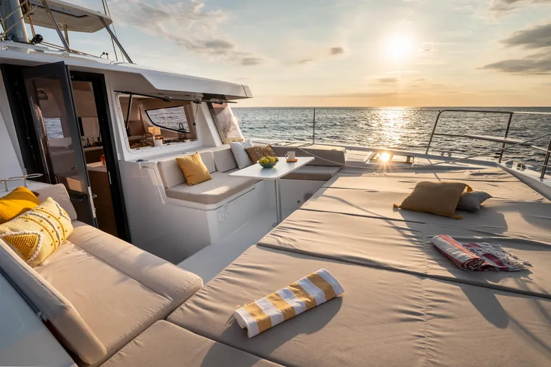  Yacht Photos Pics Luxurious Bali 4.4 yacht deck with sunset view, featuring comfortable seating and cushions, 2026 model.