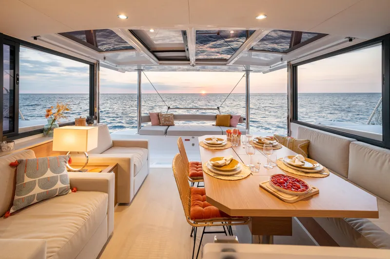 Yacht Photos Pics Luxurious Bali 4.4 yacht interior with elegant dining setup, ocean view, and sunset ambiance, 2026 model.