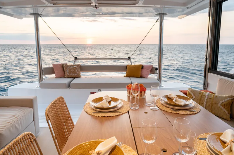  Yacht Photos Pics Luxurious Bali 4.4 yacht dining area with ocean view, set for sunset dinner, 2026 model.