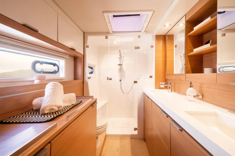  Yacht Photos Pics Luxurious bathroom in 2026 Bali 4.4 yacht, featuring modern fixtures and elegant wood finishes.