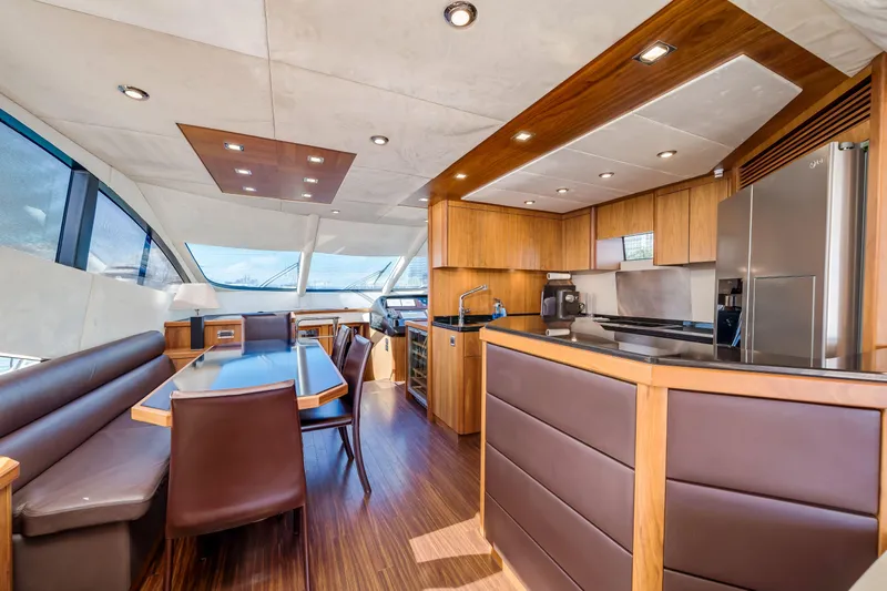 Twins Yacht Photos Pics Luxurious interior of 2009 Sunseeker Manhattan 70 yacht with modern kitchen and dining area.