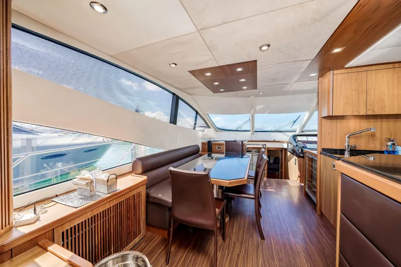 Twins Yacht Photos Pics Luxurious interior of 2009 Sunseeker Manhattan 70 yacht with elegant dining area and modern kitchen.