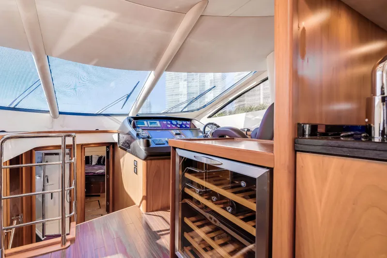 Twins Yacht Photos Pics Interior of 2009 Sunseeker Manhattan 70 yacht with modern helm and wine cooler.
