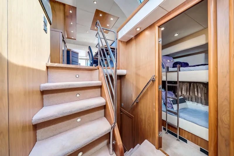 Twins Yacht Photos Pics Interior of 2009 Sunseeker Manhattan 70 yacht, featuring stairs and cozy bunk beds.
