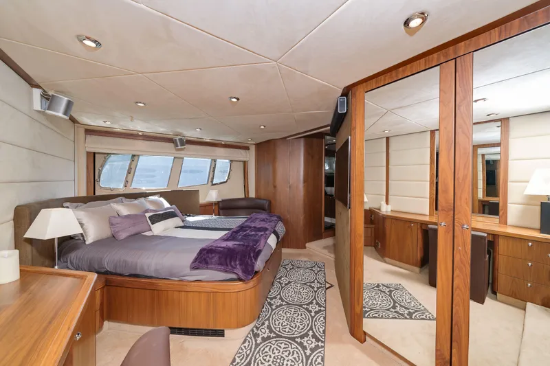 Twins Yacht Photos Pics Luxurious bedroom interior of 2009 Sunseeker Manhattan 70 yacht with elegant wood finishes.