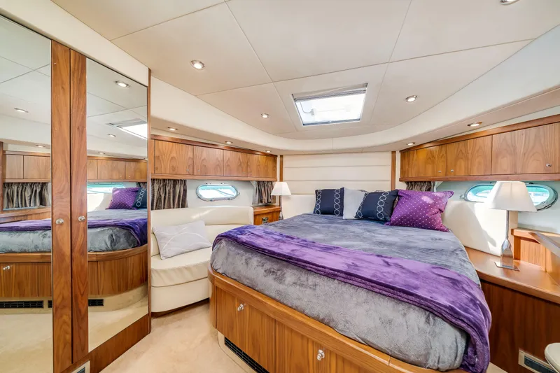 Twins Yacht Photos Pics Luxurious bedroom interior of 2009 Sunseeker Manhattan 70 yacht with elegant wood finishes.
