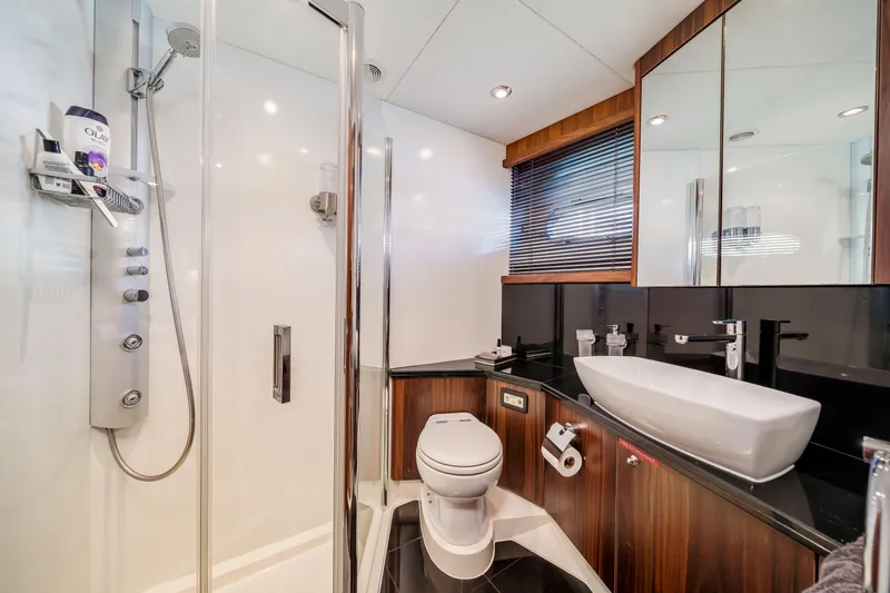 Twins Yacht Photos Pics Luxurious bathroom in 2009 Sunseeker Manhattan 70 yacht with modern fixtures and sleek design.