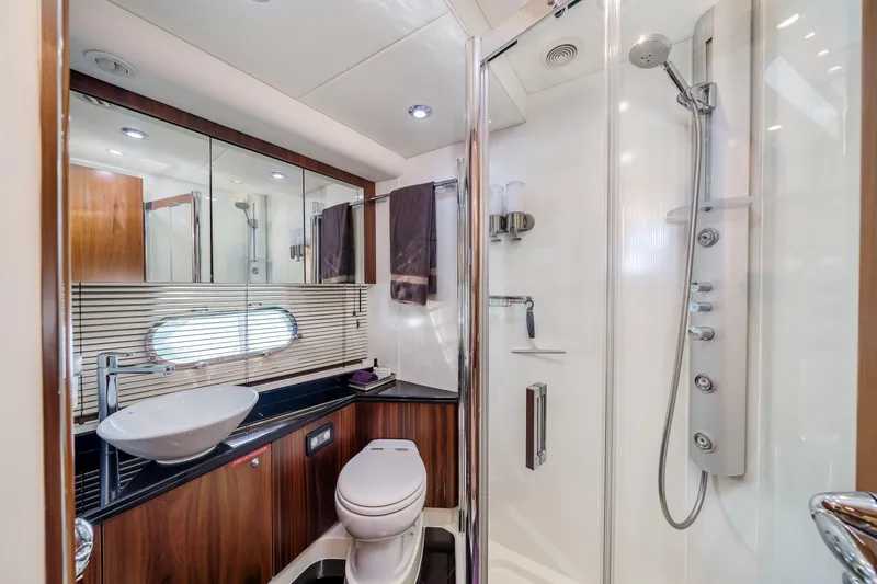 Twins Yacht Photos Pics Luxurious bathroom in 2009 Sunseeker Manhattan 70 yacht with modern fixtures and elegant design.