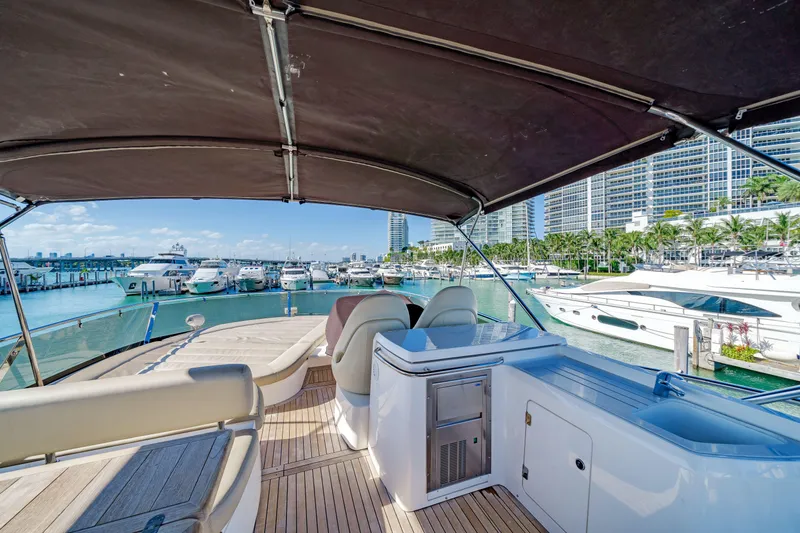 Twins Yacht Photos Pics 2009 Sunseeker Manhattan 70 yacht interior with marina view, featuring luxurious seating and amenities.