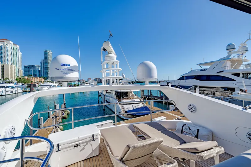 Twins Yacht Photos Pics 2009 Sunseeker Manhattan 70 yacht docked in a marina with city skyline.