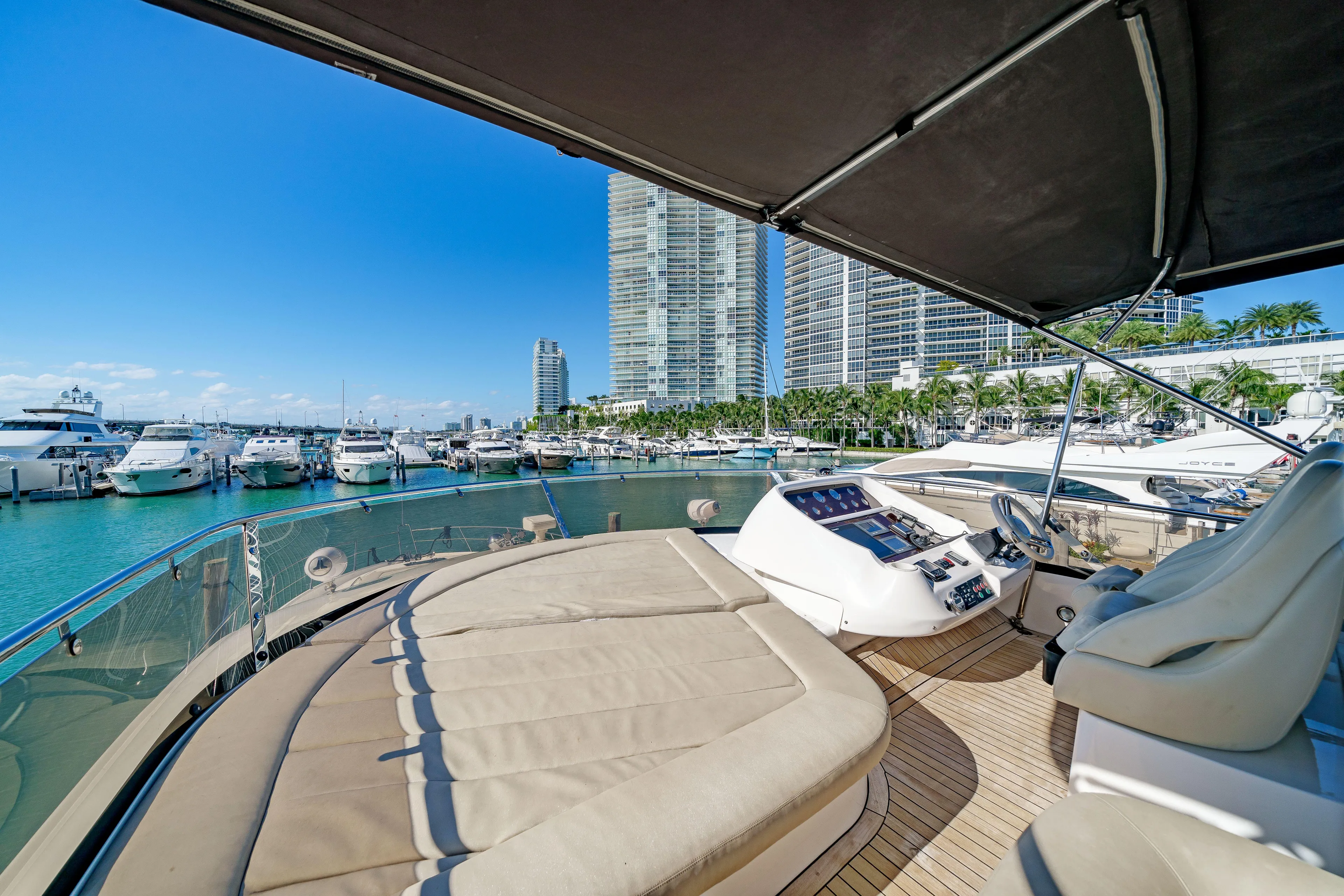 Twins Yacht Photos Pics Luxurious 2009 Sunseeker Manhattan 70 yacht docked in a marina with cityscape views.