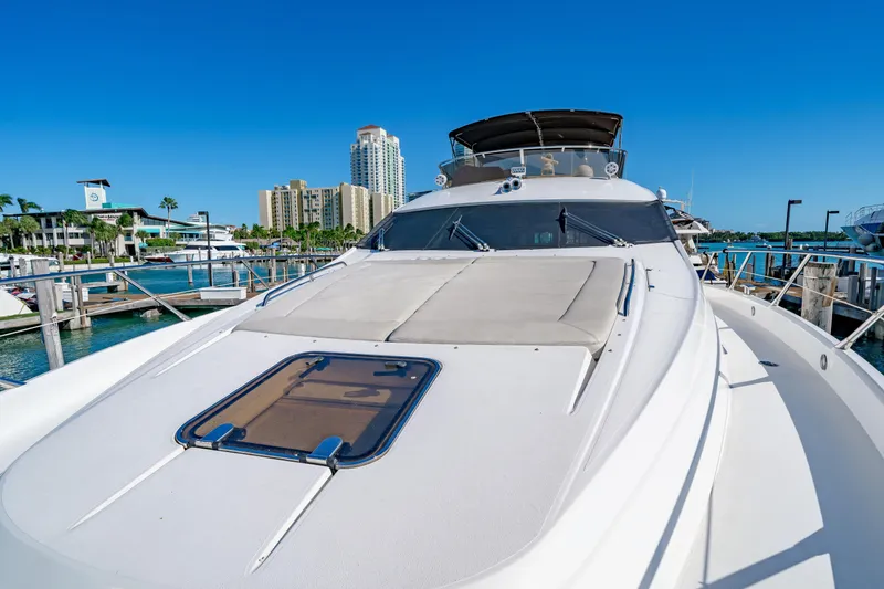 Twins Yacht Photos Pics 2009 Sunseeker Manhattan 70 yacht docked at marina with cityscape background.