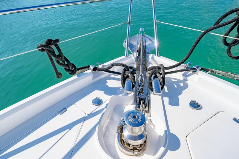 Twins Yacht Photos Pics Bow of 2009 Sunseeker Manhattan 70 yacht with anchor and ropes on turquoise water.